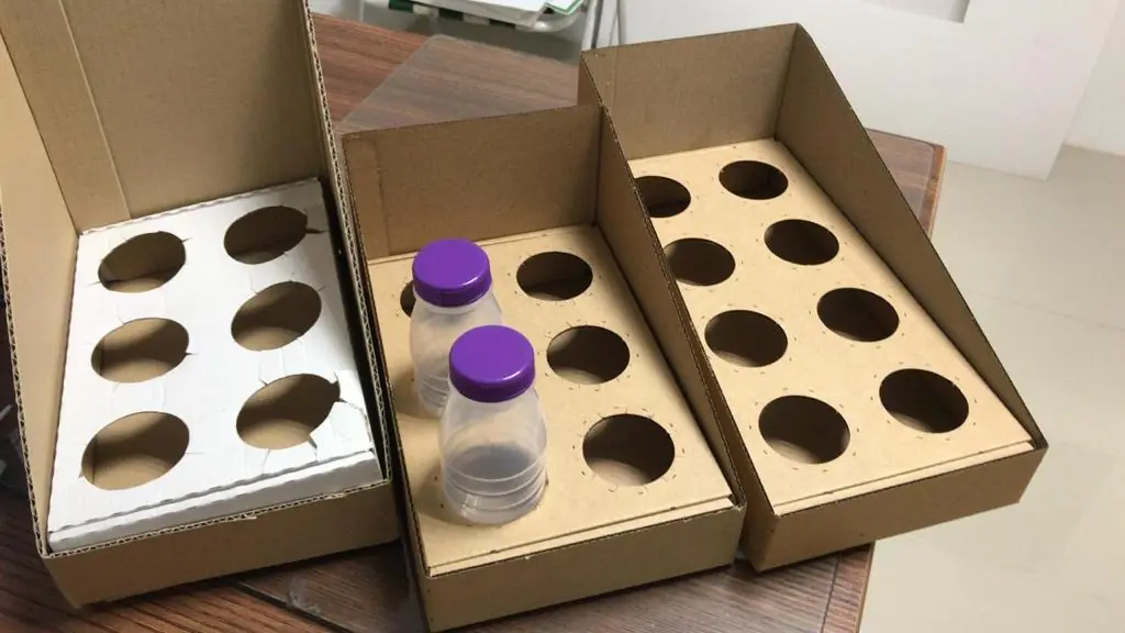 Corrugated inner trays with circular cut-outs holding bottles
