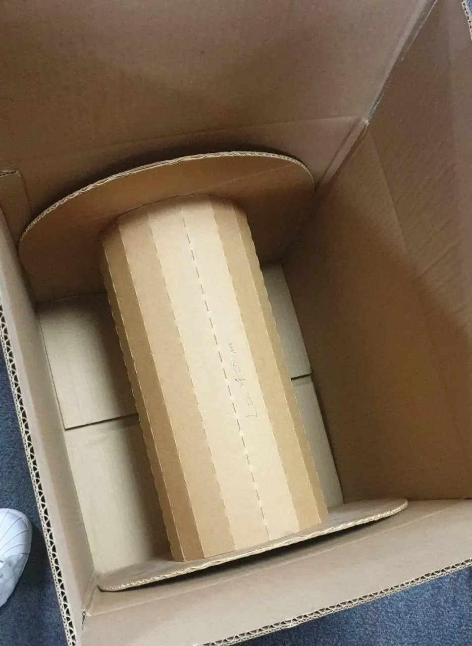 Cylindrical corrugated core packed inside a carton